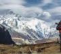 Photographer overlooking Kanchenjunga and Goecha Peak near Lamuney campsite on the Goechala Trek route in Sikkim
