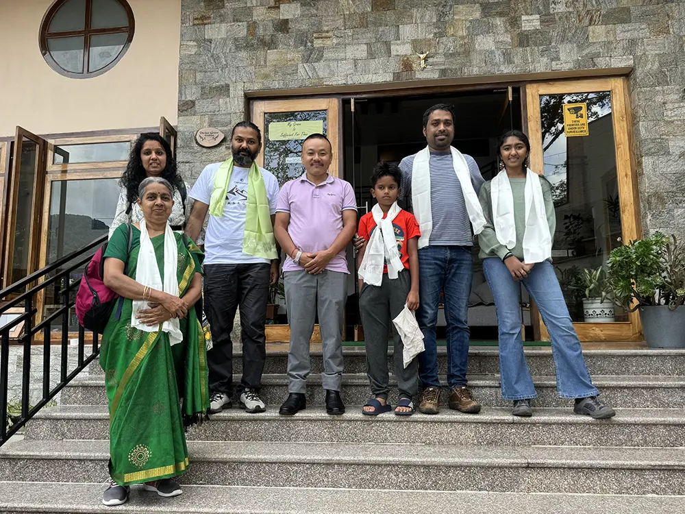 Jeepa Travel Sikkim owner Jiwan Subba welcoming a family of tourists at the Gangtok office