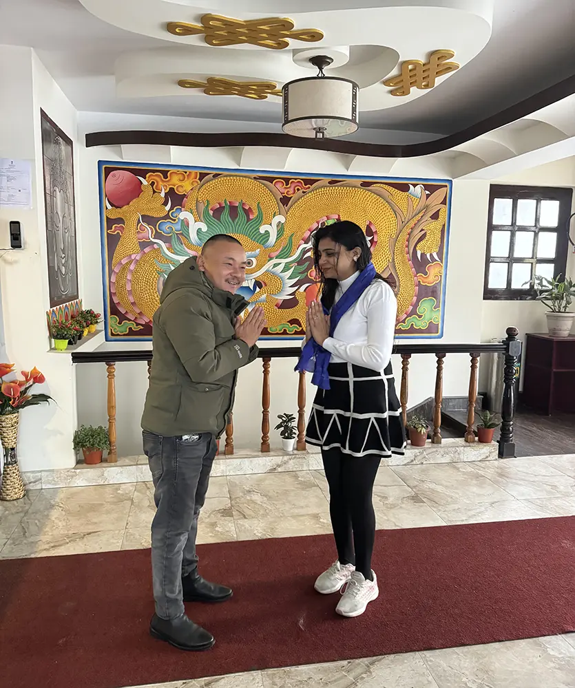 Jiwan Subba greeting a guest with traditional hospitality at Jeepa Travel Sikkim